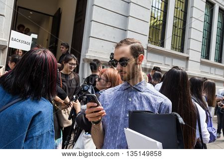 MILAN ITALY - JUNE 18: Fashionable people gather outside Marni fashion show building for Milan Men's Fashion Week on JUNE 18 2016 in Milan.