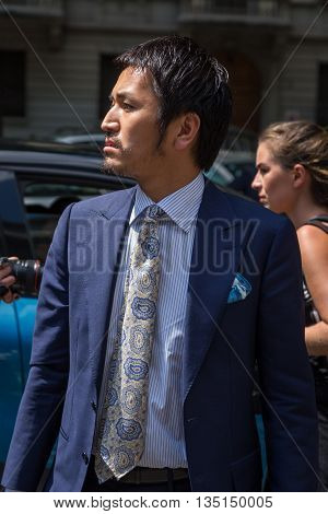 MILAN ITALY - JUNE 18: Fashionable man poses outside Marni fashion show building for Milan Men's Fashion Week on JUNE 18 2016 in Milan.