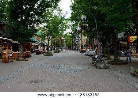 Zakopane Poland - June 15 2016: Krupowki street in Zakopane in Poland. Unidentified people visible.