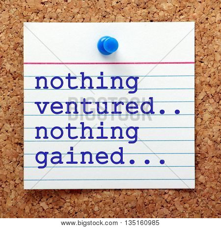 The phrase Nothing Ventured Nothing Gained on a note card pinned to a cork notice board as a reminder