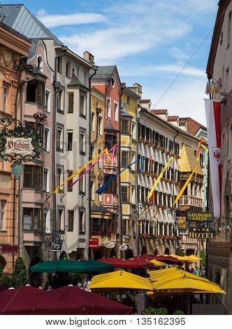INNSBRUCK AUSTRIA - 18TH JUNE 2016: Restaurants and patios along Herzog Friedrich Strasse in the central district of Innsbruck during the day.