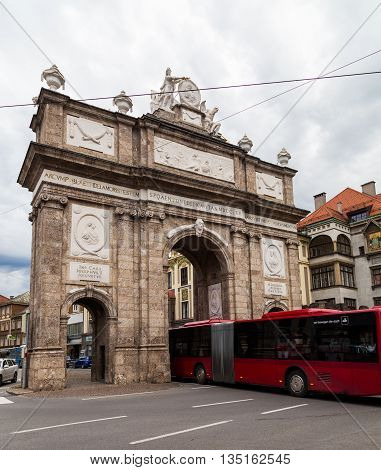 INNSBRUCK AUSTRIA - 18TH JUNE 2016: The Triumphpforte (Triumphal Arch) in central Innsbruck during the day. A bus can be seen going through it.