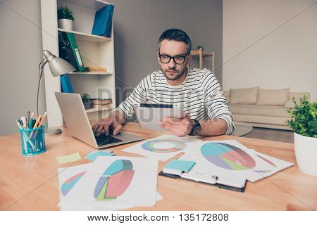 Smart Man In Glasses Holding Tablet And Working With Diagramas