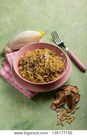 tagliolini with dried mushroom pinenuts and endive salad 
