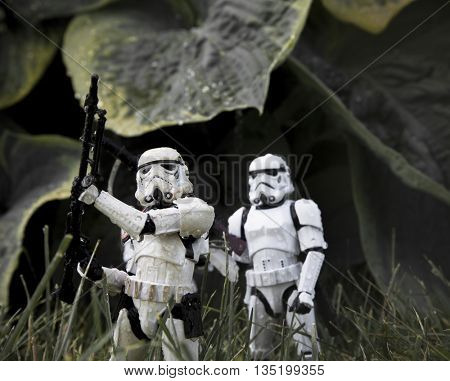 BLOOMFIELD NJ - JUNE 19 2016: Star Wars Stormtrooper action figures creating a fantasy scene in a rainy swamp