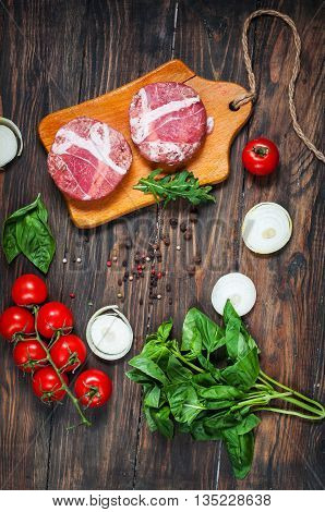 Ingredients for making homemade burger on wooden cutting board. Top view.