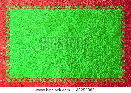 Shiny red frame with a pattern on the green foil background.