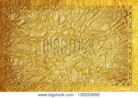 Shiny gold frame with a pattern on the dark gold foil background.
