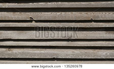background trees horizontal stripes from the wooden garage where there are cars