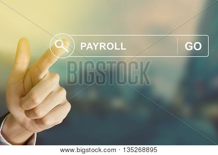 business hand clicking payroll button on search toolbar with vintage style effect