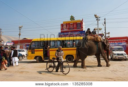 ALLAHABAD, INDIA - JAN 25, 2013: Elephant and the indian people on the bus stop of biggest festival in the world - Kumbh Mela on January 25, 2013 in Allahabad India. Mela 2013 had take 130 000 000 visitors