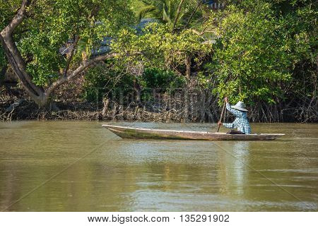 Oarsman on the river. That is a lifestyle of people's riverside in Thailand.
