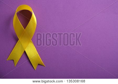 Yellow ribbon on purple background