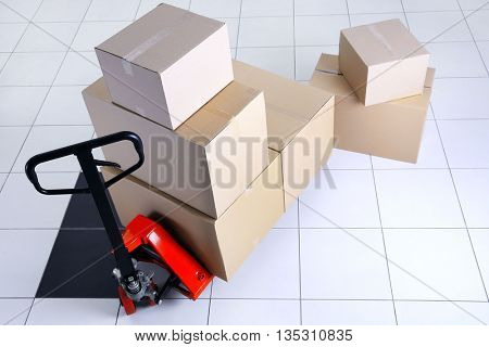 Manual pallet truck with carton boxes indoors
