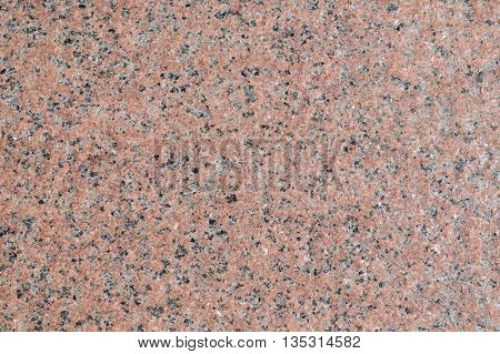 Surface of the walls with light pink granite with brown gray and white patches.