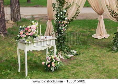 Vintage boudoir is in the shade on a beautiful lawn, behind the arch