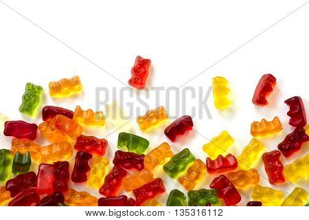 colorful fruit gum candy bears isolated with small shadow on white as a background frame can be used horizontally or vertically