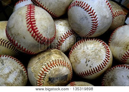 Pile and stack of old worn baseballs for sports and recreation pasttime