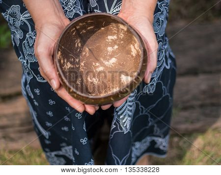 Coconut bowl on hand, concept ask for