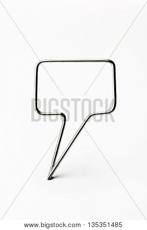 Chrome wire tweet or remark. Blank speech bubble made of chrome wire isolated on white. Ready for inserting text. Shallow depth of field.