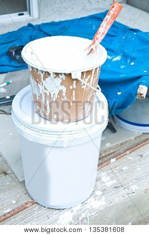 a paint bucket with paint in construction