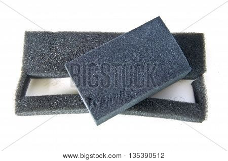 Sponge for cleaning of black footwear on a white background.