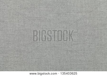 light gray background from a textile material. Fabric with natural texture. Cloth backdrop.