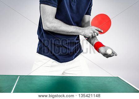 Mid section of athlete man playing table tennis against grey background