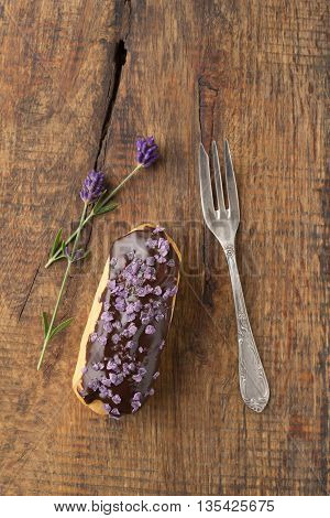 Eclair with chocolate ganache with candied lavender topping