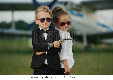 photo of young boy and girl playing spy