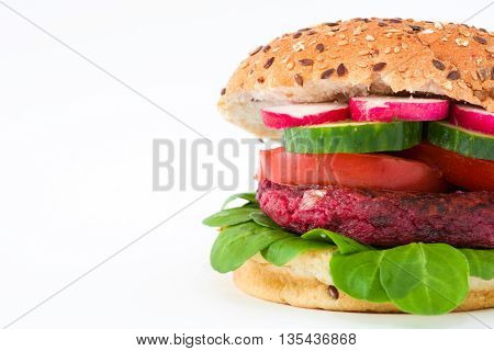 Vegan beetroot burger with lamb's lettuce, tomato, cucumber and radish isolated on white background