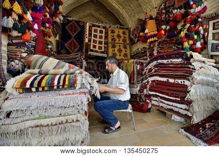 SHIRAZ - APRIL 14: Traditional iranian carpets in a market (Vakil Bazaar) in Shiraz Iran on April 14 2015. Vakil Bazaar is the most important tourist attraction in Shiraz Iran.