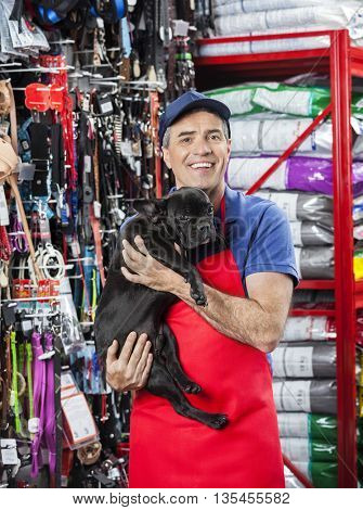 Happy Salesman Carrying French Bulldog In Pet Store