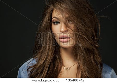 Close Up Portrait Of A Beautiful Girl With A Voluminous Hair And Professional Make-up On A Backgroun