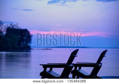 Lake view during sunset at the cottage from the dock against a beautiful purple sky