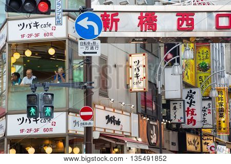 TOKYO, JAPAN - June 22 2016: Busy street in the Shimbashi district, where local businessmen take their lunch break. Tokyo, Japan 2016
