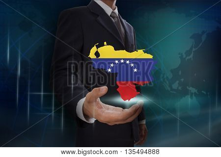 Businessman showing map of Venezuela on globe background