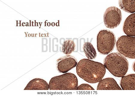 Decorative edging pieces of black rye bread on a white background. Isolated. Border. Pattern. Food background. View from above.