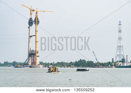 Cao Lanh Vietnam - March 17 2016: Car ferries in the Mekong Delta of Vietnam are rapidly being replaced by motorway bridges like here near Cao Lanh the capital of Dong Thap Province.