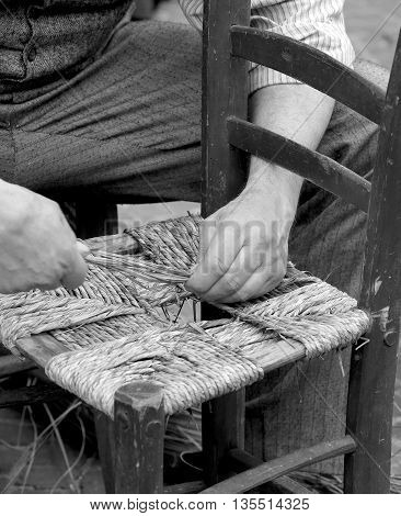 Old Man Mender Of Chairs While Repairing Old Wooden Chair