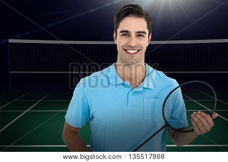 Composite image of badminton player holding badminton racket against badminton field