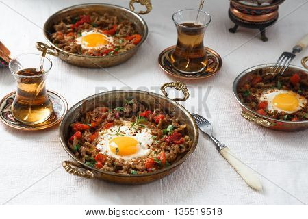 Fried egg with mince meat in traditional turkish pan.