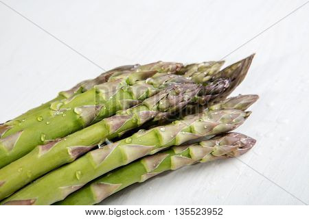 Green wet asparagus on the table
