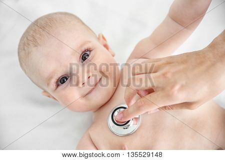 Professional pediatrician examining infant