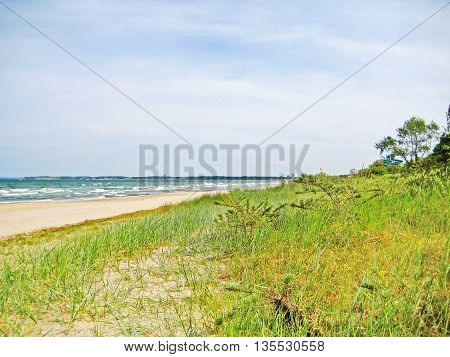 Beach between Timmendorfer Strand and Scharbeutz - dunes with grass and trees sandy beach and ocean