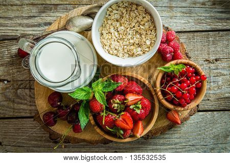 Oatmeal with berries on rustic wood background, copy spce