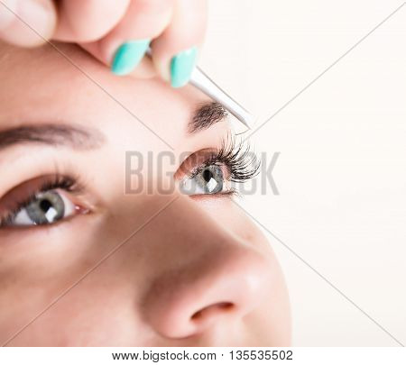 Beautiful young woman eyelash extension. Woman eye with long eyelashes. Beauty salon concept.