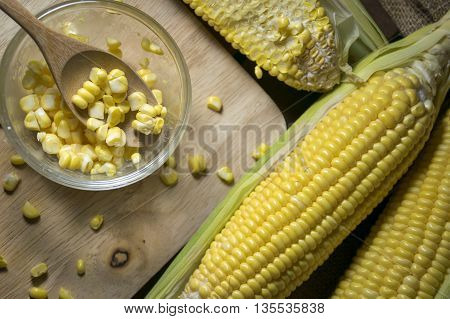Corn and corn slide in a cup with wooden spoon