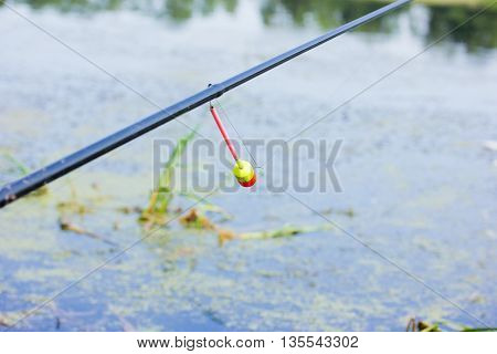 The tip of the rod with the bell.