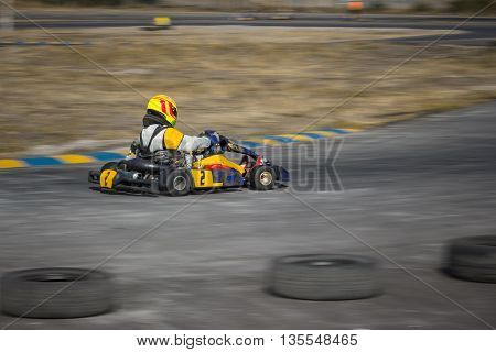 Karting - driver in helmet driving on kart circuit